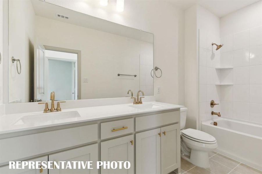 Guests will enjoy having their own vanity space in this lovely guest bathroom.