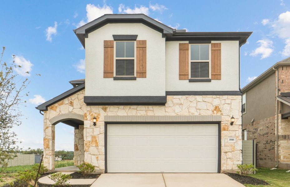 Front exterior of a new home in Wolf Ranch, Georgetown, TX, highlighting curb appeal (Image 2). Front exterior of a new home in Wolf Ranch, Georgetown, TX, highlighting curb appeal (Image 2).