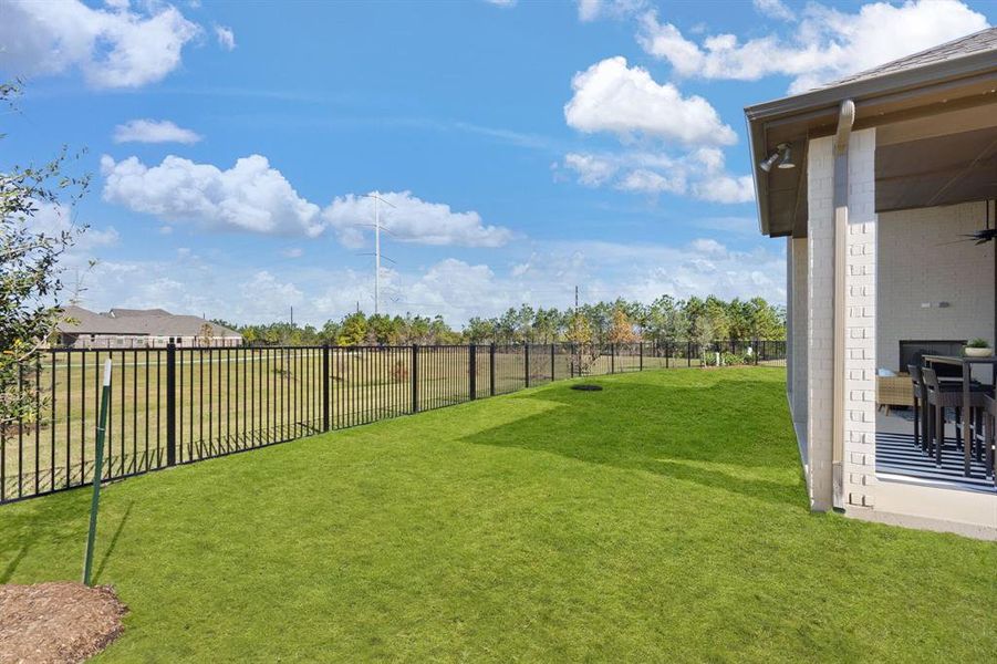 10,000+ sf lot with wrought iron fencing and serene water views