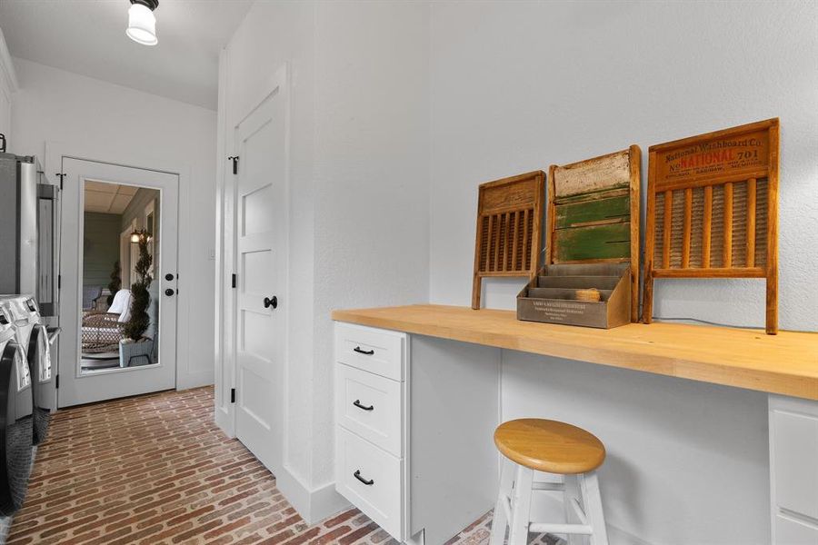 Laundry/mudroom in home number one features custom brick lay flooring