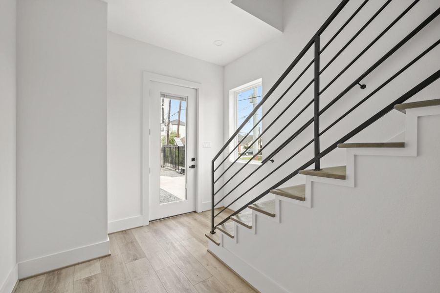 Allowing plenty of light into the entryway through the beautiful glass door and the fixed window, this spacious area offers the ideal layout for a console table or a reading nook. Allowing plenty of light into the entryway through the beautiful glass door and the fixed window, this spacious area offers the ideal layout for a console table or a reading nook.