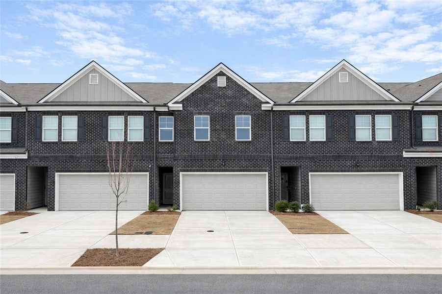 Front exterior of a new home in Reeves Park, Stockbridge, GA, highlighting curb appeal (Image 2). Front exterior of a new home in Reeves Park, Stockbridge, GA, highlighting curb appeal (Image 2).