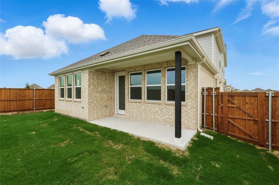 Rear view of property featuring a fenced backyard, a gate, brick siding, and a patio Rear view of property featuring a fenced backyard, a gate, brick siding, and a patio