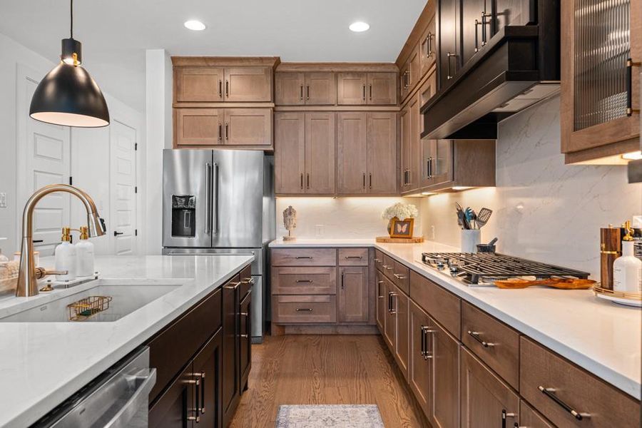 Culinary aspirations meet elegant design in this well-appointed kitchen featuring a gas cooktop and stainless steel appliances. Culinary aspirations meet elegant design in this well-appointed kitchen featuring a gas cooktop and stainless steel appliances.