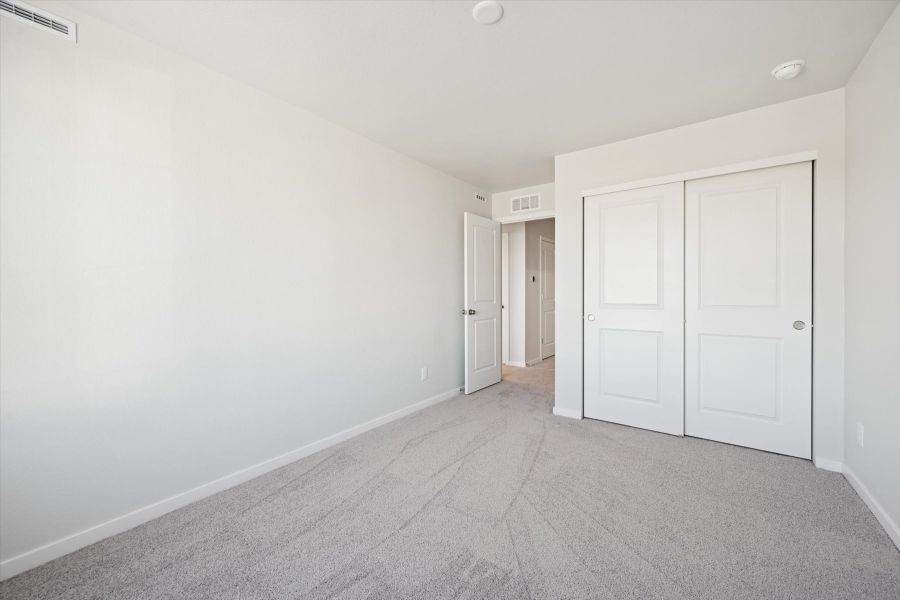 A hallway with white doors.