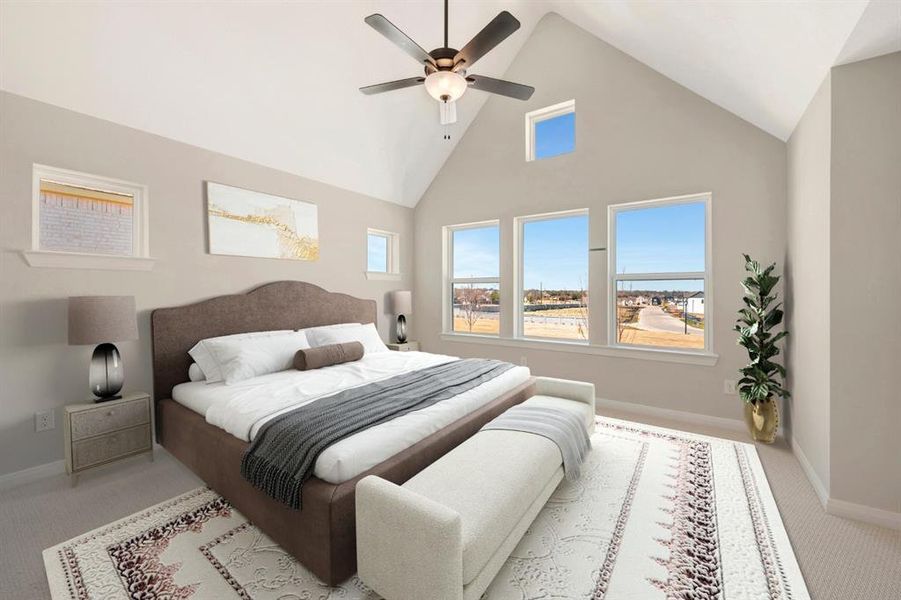 Carpeted bedroom featuring a high ceiling and a ceiling fan