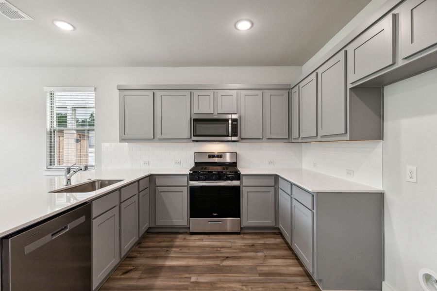 Kitchen in the Hickory home plan by Trophy Signature Homes – REPRESENTATIVE PHOTO