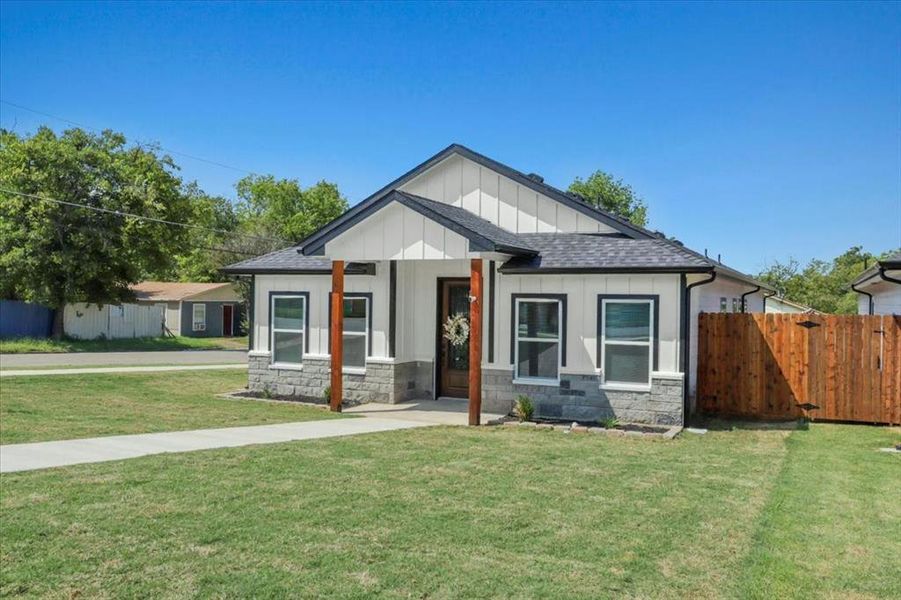 View of front of house with board and batten siding, a shingled roof, stone siding, and covered porch View of front of house with board and batten siding, a shingled roof, stone siding, and covered porch