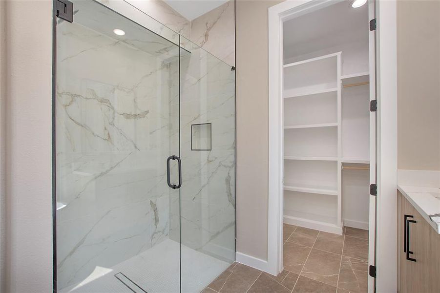 Bathroom featuring vanity, tile patterned flooring, and an enclosed shower