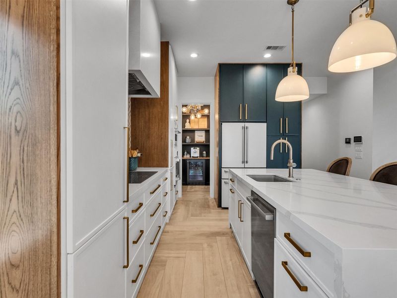 Every inch of this kitchen was designed for beauty and purpose. High-end Café appliances, a Monogram cooktop, and soft-close cabinetry create a space that’s both functional and elegant. The herringbone wood-look tile adds warmth, while the reverse osmosis system delivers purified water to both the refrigerator and coffee nook. Every inch of this kitchen was designed for beauty and purpose. High-end Café appliances, a Monogram cooktop, and soft-close cabinetry create a space that’s both functional and elegant. The herringbone wood-look tile adds warmth, while the reverse osmosis system delivers purified water to both the refrigerator and coffee nook.