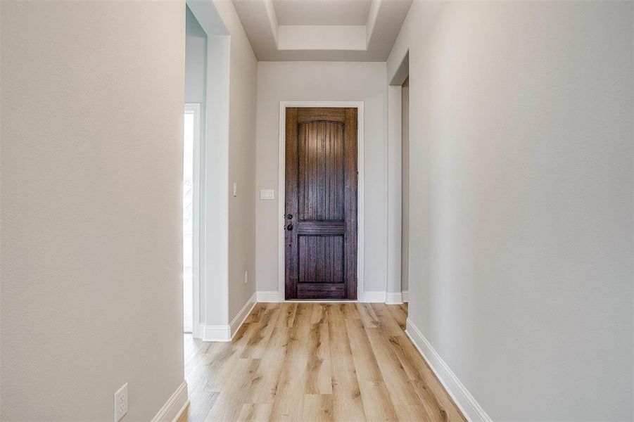 Hall with light hardwood / wood-style flooring