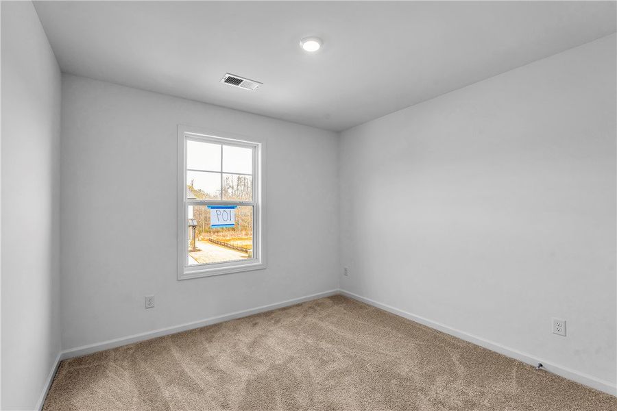 This spacious bedroom offers ample natural light a