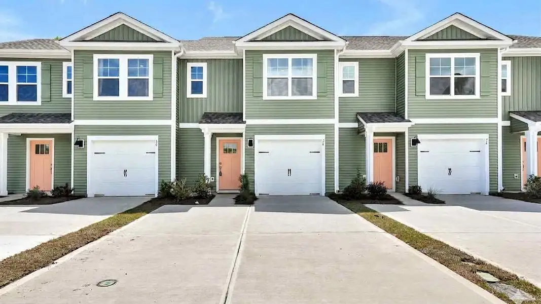 Front exterior of a new home in Townes at Seabrooke, Leland, NC, highlighting curb appeal (Image 1). Front exterior of a new home in Townes at Seabrooke, Leland, NC, highlighting curb appeal (Image 1).