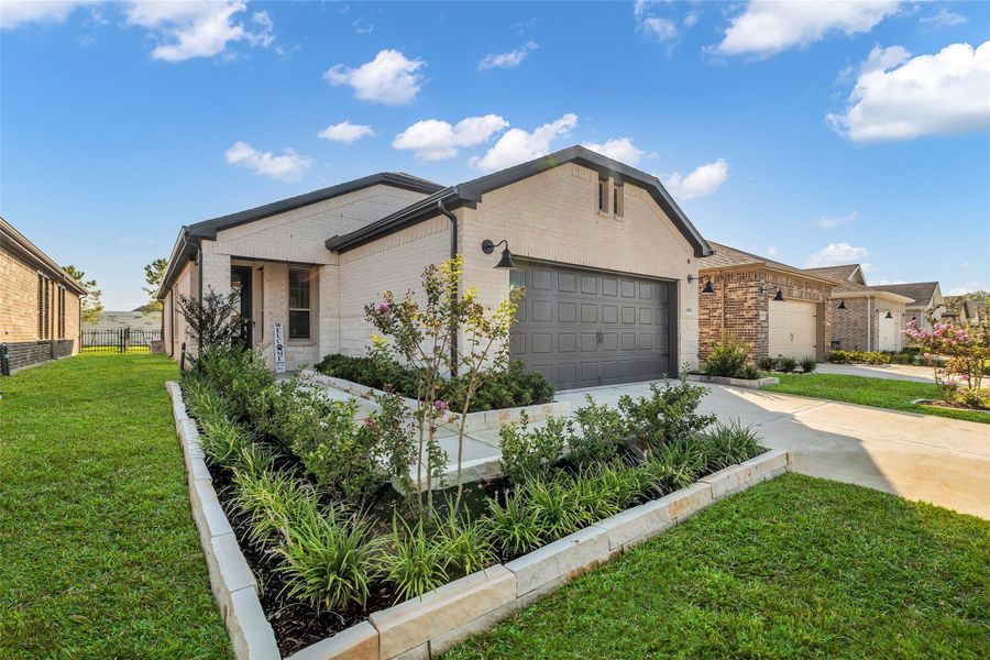 Custom built flowerbeds matching the limestone e & brick exterior
