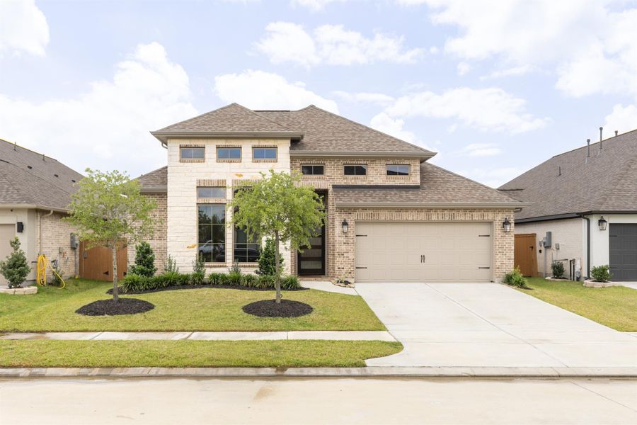 Front exterior of a new home in Marvida, Cypress, TX, highlighting curb appeal (Image 20).