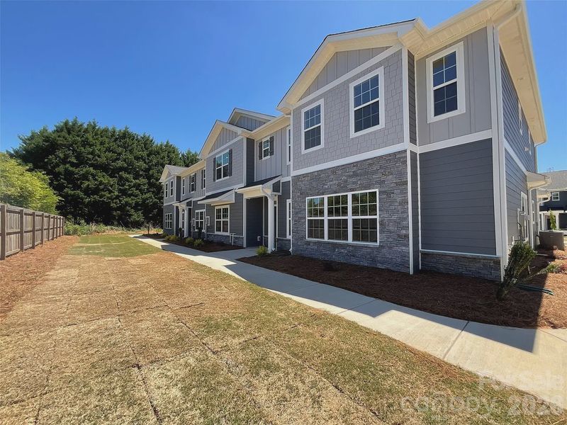 Front exterior of a new home in Pine Trace, Gastonia, NC, highlighting curb appeal (Image 10). Front exterior of a new home in Pine Trace, Gastonia, NC, highlighting curb appeal (Image 10).