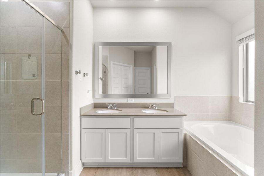 Designed to support the morning routine with ease, the primary ensuite features dual vanities, a dedicated glass-enclosed shower, and a soaking tub, allowing multiple functions to happen comfortably at once.