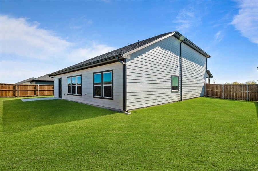 Rear view of house featuring a yard Rear view of house featuring a yard