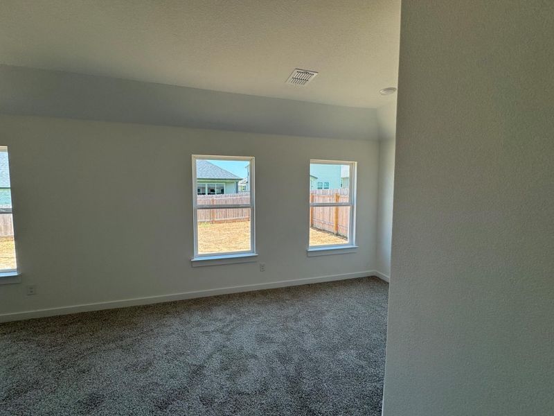 Carpeted empty room featuring baseboards Carpeted empty room featuring baseboards