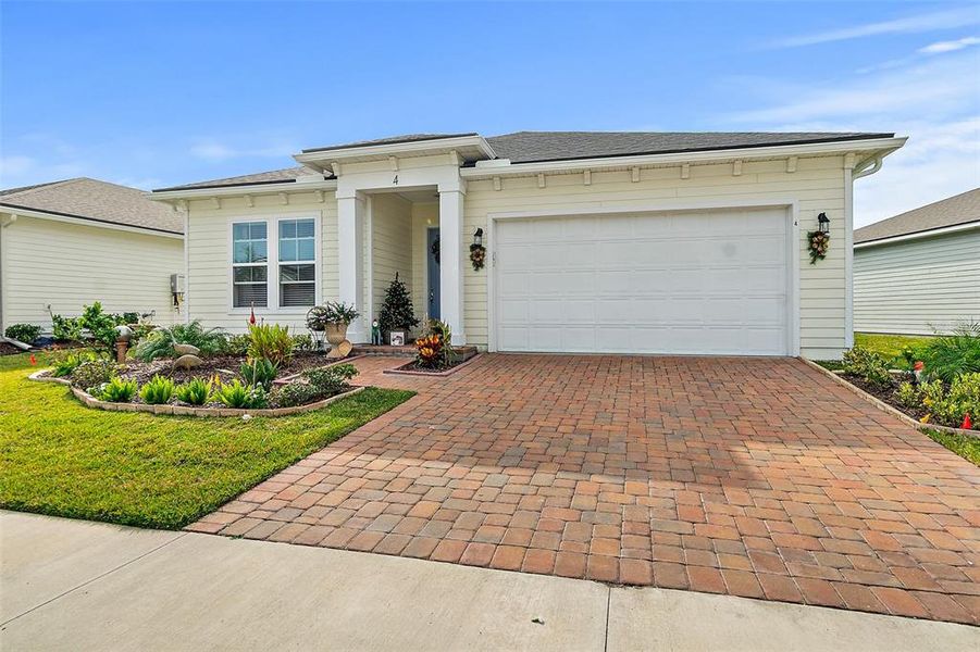 Front exterior of a new home in Reverie at Palm Coast, Palm Coast, FL, highlighting curb appeal (Image 20).