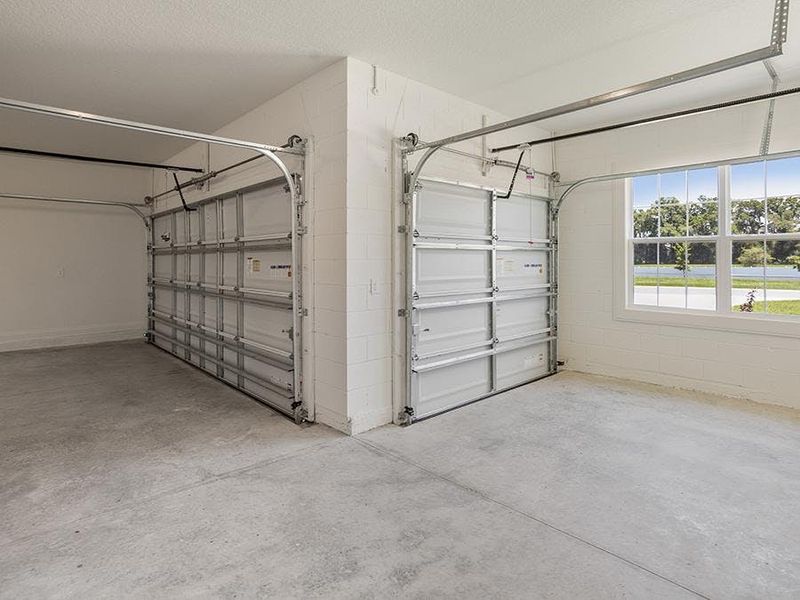 Enjoy a two-car garage, plus an additional golf cart garage or workshop - Monroe 55+ by Highland Homes