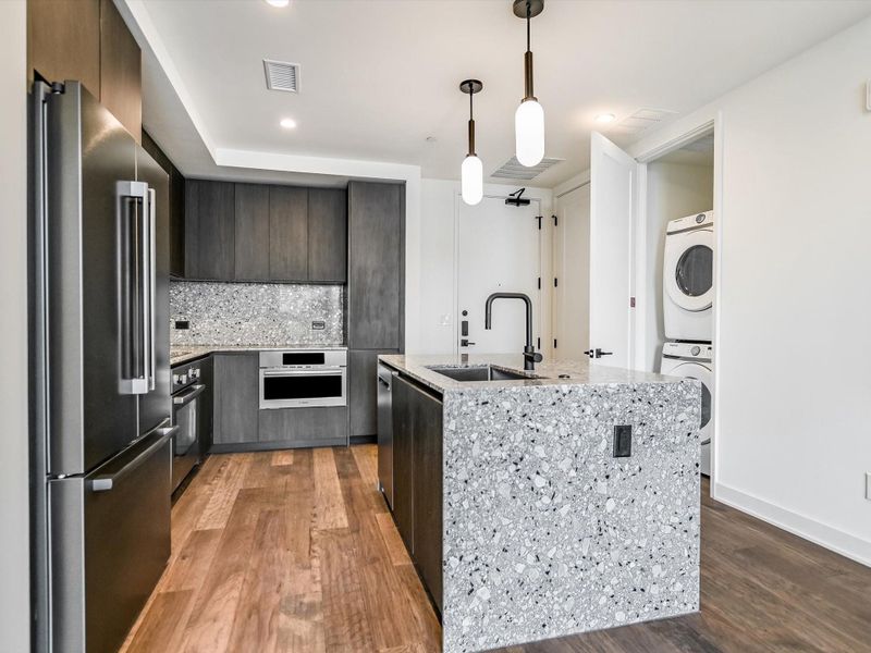 Unit 1503 comes equipped with Bosch stainless steel appliances and Samsung washer and dryer