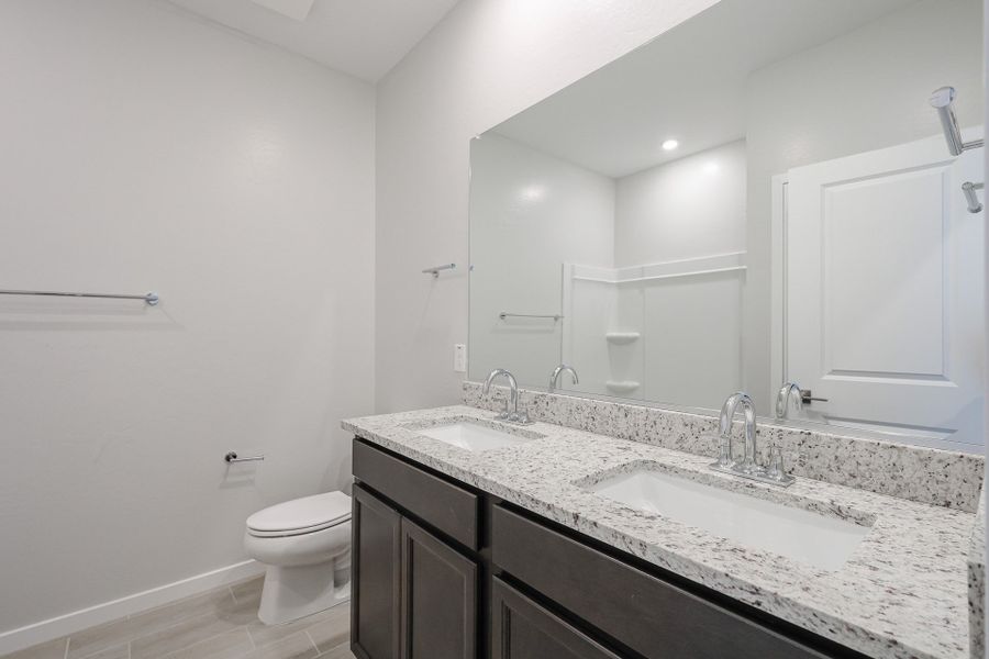 A bathroom with a large mirror.