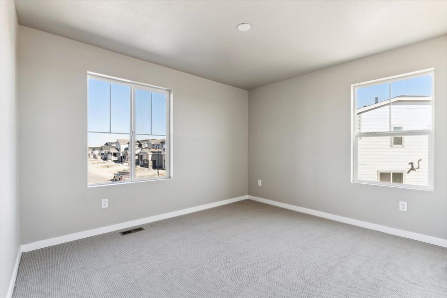 A room with a window and a white wall.