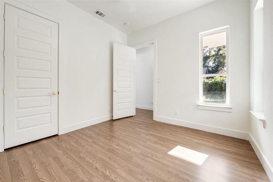 Unfurnished bedroom featuring baseboards and light wood-type flooring Unfurnished bedroom featuring baseboards and light wood-type flooring