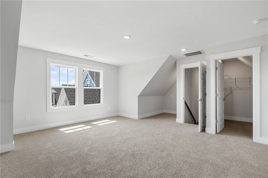 A versatile bonus room offering abundant natural l