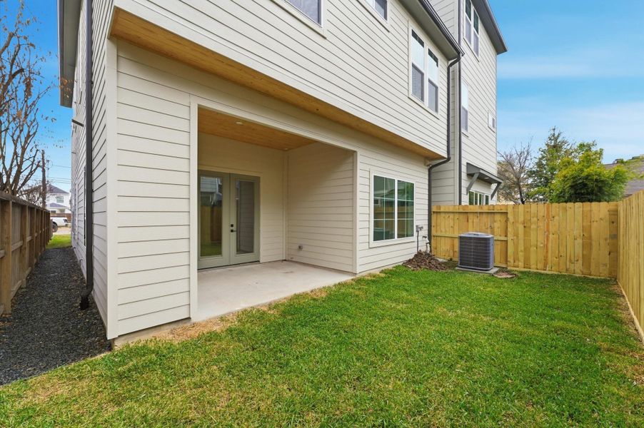 Covered patio leads to the welcoming backyard.