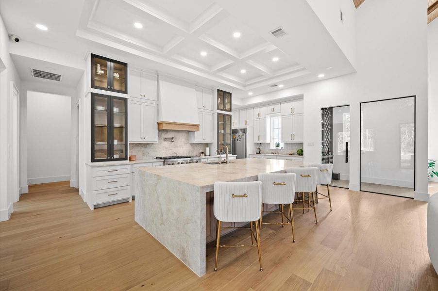 Chef's kitchen featuring Taj Mahal quartzite countertops and top-of-the-line appliances.