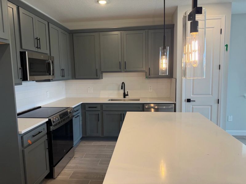 Sophisticated kitchen featuring a large kitchen island and design-centered upgrades from the AW Minimalist Collection