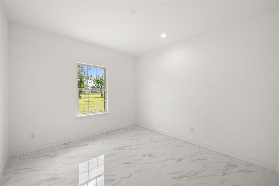 Unfurnished room with light marble finish flooring and recessed lighting Unfurnished room with light marble finish flooring and recessed lighting