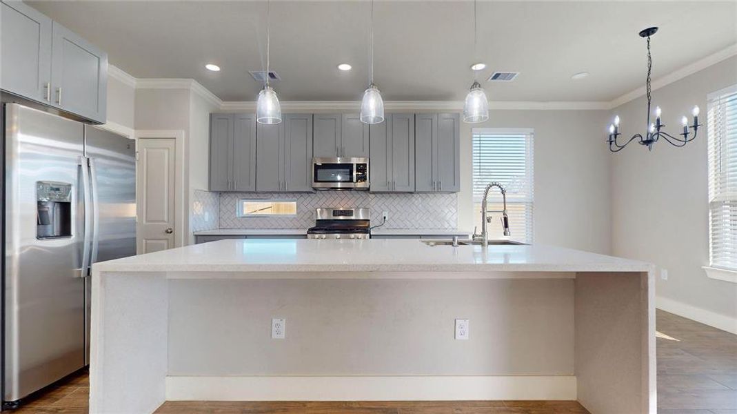 This modern kitchen has a very large island for work space as well as counter-height bar seating, lots of cabinet for storage.   All stainless steel appliances go with the property.