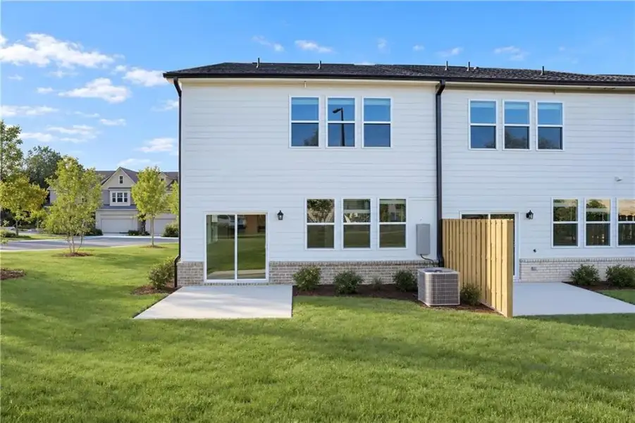 Exterior details and patio area of a home in Towns at Holly Springs, Holly Springs (Image 19).