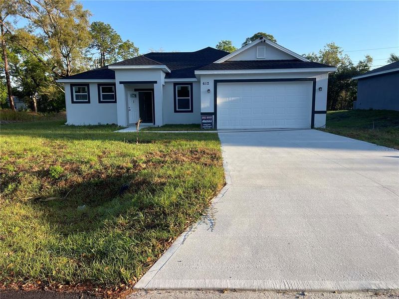Front exterior of a new home in , Palm Bay, FL, highlighting curb appeal (Image 14).