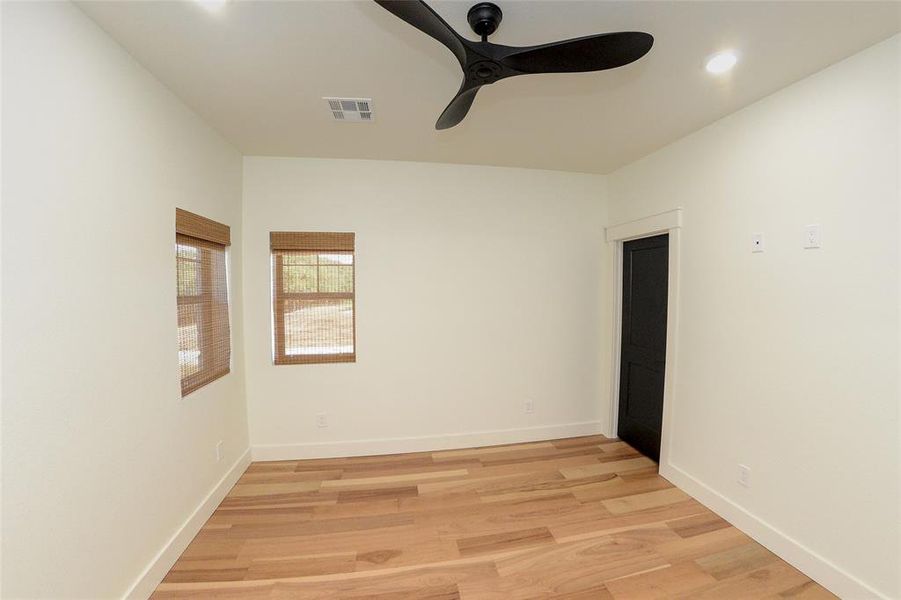 Spare room featuring a ceiling fan, light wood-style flooring, and recessed lighting