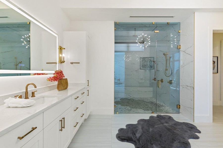 A well-appointed bathroom offers a dual-sink vanity and an elegant glass-enclosed shower.