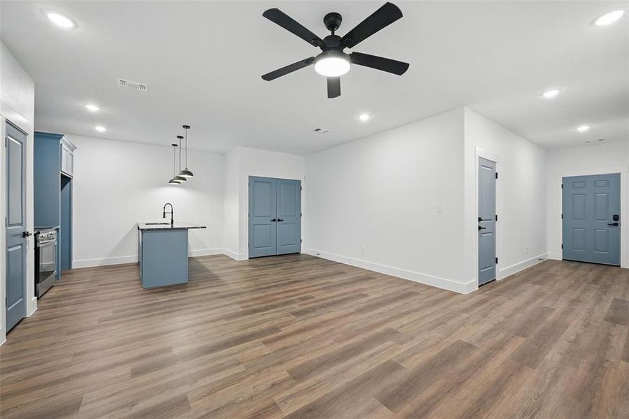 Unfurnished living room featuring recessed lighting, a ceiling fan, and wood finished floors