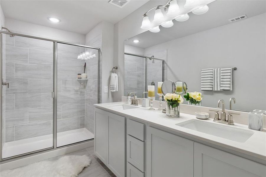 Bathroom with a shower with door and vanity