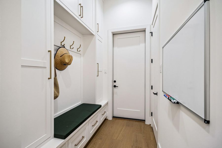 The mudroom and storage area, located just off the kitchen, provides convenient access to the garage.