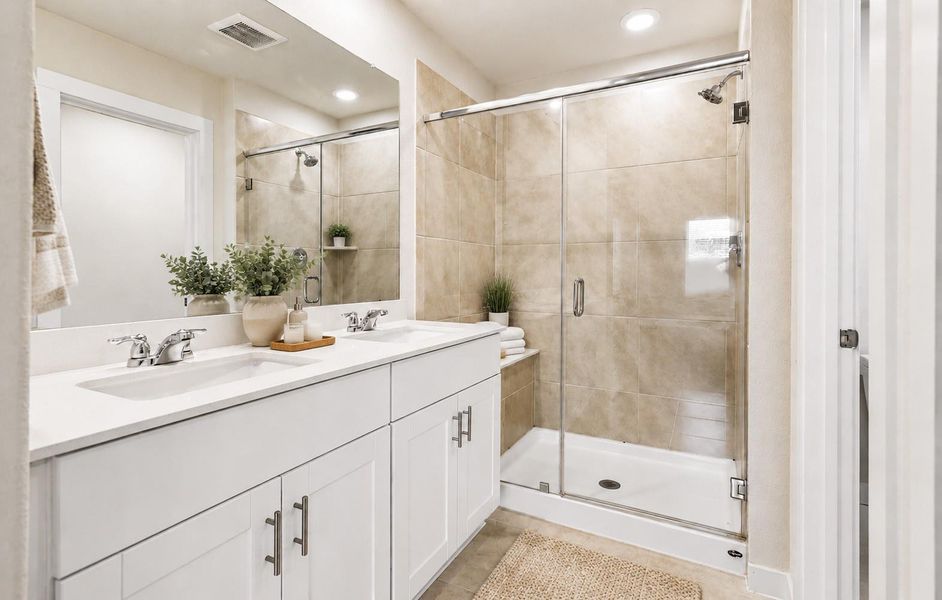 The spa-like ensuite bathroom offers dual sinks, walk-in shower, and generous storage space. (photo has AI edits) The spa-like ensuite bathroom offers dual sinks, walk-in shower, and generous storage space. (photo has AI edits)