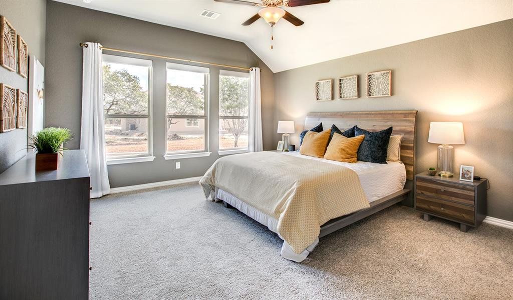 Bedroom with carpet, lofted ceiling, and ceiling fan Bedroom with carpet, lofted ceiling, and ceiling fan