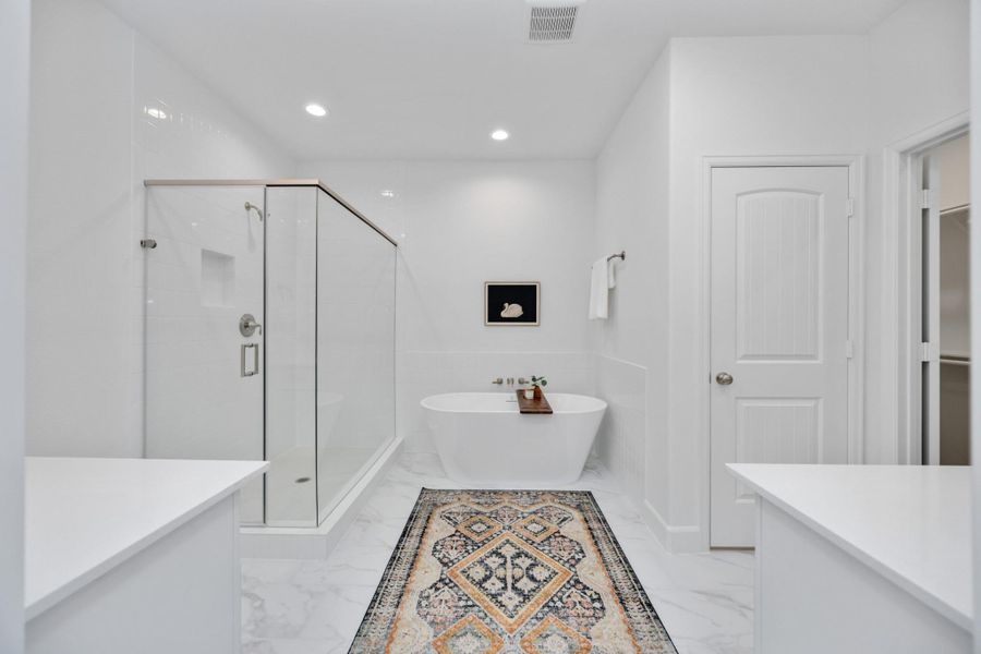 Soak away the stress of the day in your freestanding tub while your favorite playlist echoes off spa-white walls. This luxury en suite was made for unwinding.