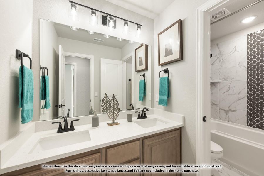 Bathroom with double sink vanity, large mirror, and tiled shower with marble and hexagon tile accents Bathroom with double sink vanity, large mirror, and tiled shower with marble and hexagon tile accents