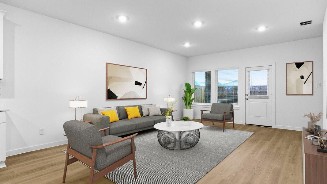 A well-organized living room that includes a kitchen and dining area, creating a warm and welcoming environment for gatherings.