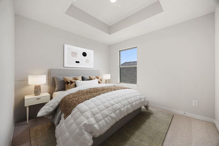 This secondary bedroom features an elegant tray ceiling with recessed lighting, custom paint, plush carpet, large window, and an ample sized closet. *Virtually Staged This secondary bedroom features an elegant tray ceiling with recessed lighting, custom paint, plush carpet, large window, and an ample sized closet. *Virtually Staged