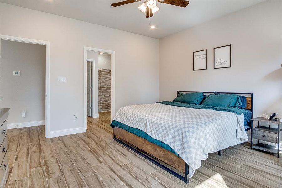 Bedroom featuring wood tiled floors, ceiling fan, and recessed lighting