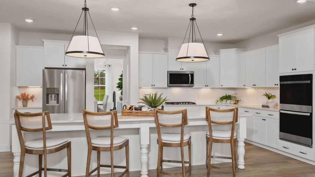 Stonefield home plan open concept kitchen with massive island and abundant cabinetry overlooking the family room/breakfast Stonefield home plan open concept kitchen with massive island and abundant cabinetry overlooking the family room/breakfast